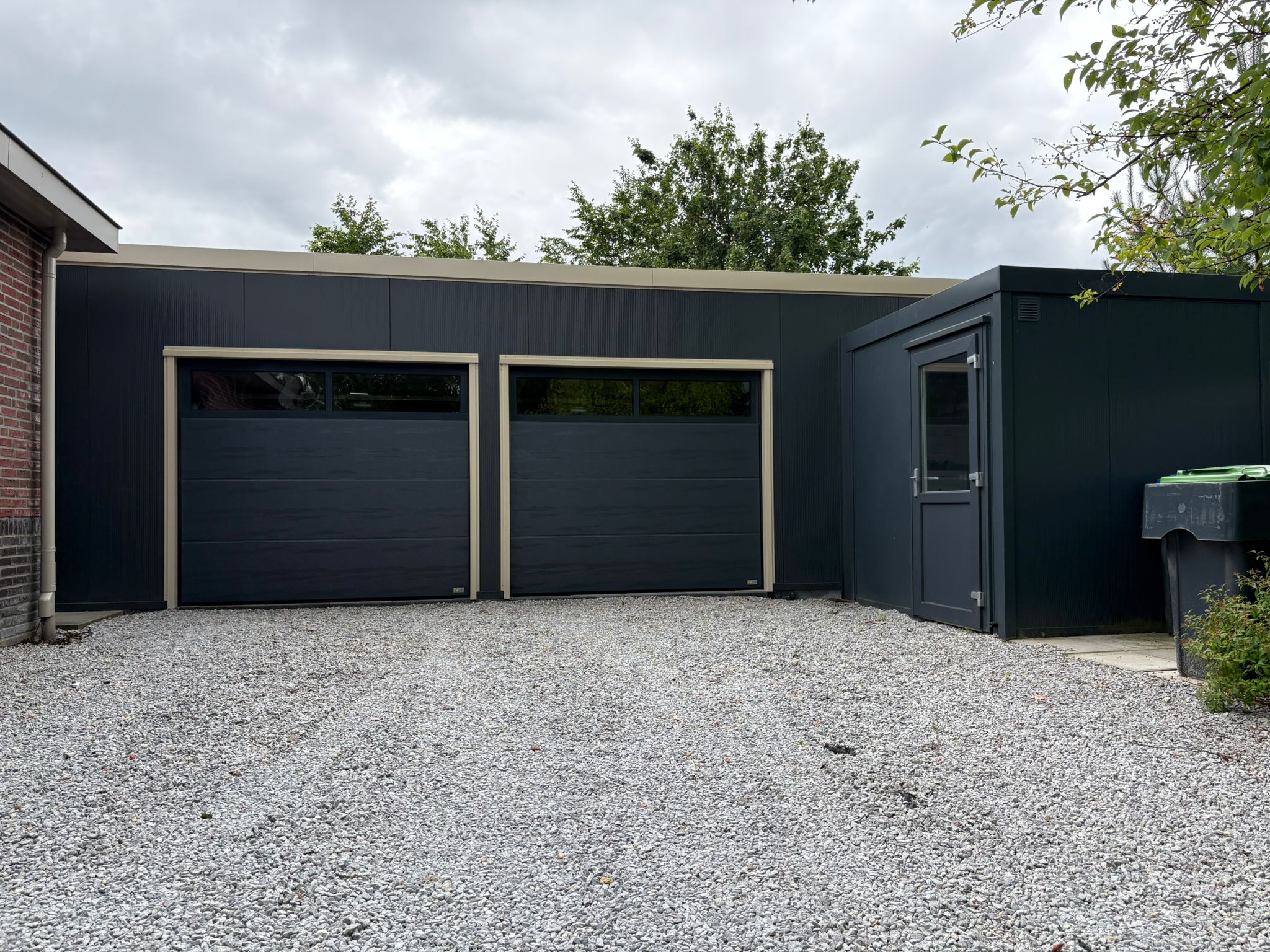 Groby garage Elspeet garagedeuren met aangekoppelde berging loopdeur grindverharding
